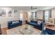 The stylish living room includes modern decor, a gray rug, hardwood floors and lots of natural lighting at 4228 Laurel Creek Se Ct # 6, Smyrna, GA 30080