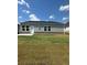 Backyard view of house showing a grassy lawn and exterior, with multiple windows at 710 Pineberry Ct, Grayson, GA 30017