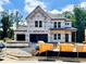 New construction home featuring a two-car garage, covered entry, and Kingspan GreenGuard weather barrier at 723 Crest Line Trl, Powder Springs, GA 30127