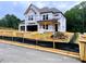 Two story home in progress featuring a two car garage and weather barrier at 723 Crest Line Trl, Powder Springs, GA 30127