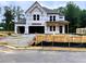 New construction featuring a two-story home with a two-car garage and covered porch at 723 Crest Line Trl, Powder Springs, GA 30127