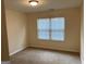 Neutral bedroom with carpeted flooring, and a window bringing in natural light at 7981 Gossamer Dr, Fairburn, GA 30213
