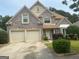 Charming two-story home with brick facade, well-manicured landscaping and an attached two-car garage at 7981 Gossamer Dr, Fairburn, GA 30213