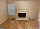 Bright living room featuring hardwood floors and a cozy fireplace at 7981 Gossamer Dr, Fairburn, GA 30213
