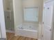 Bathroom with separate shower and tub next to window with a single sink at 7981 Gossamer Dr, Fairburn, GA 30213