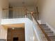 Staircase with carpeted steps, white railings, and natural light filtering into the home at 7981 Gossamer Dr, Fairburn, GA 30213