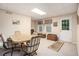 Finished basement with carpet, a table with four chairs, and an exterior door at 1625 Rushing River Way, Suwanee, GA 30024