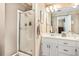 Well-lit bathroom with a shower over the tub and large mirror at 1625 Rushing River Way, Suwanee, GA 30024