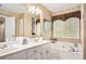 Bright bathroom with dual vanity, soaking tub, and ample counter space at 1625 Rushing River Way, Suwanee, GA 30024