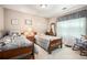 Twin beds in comfortable bedroom featuring a large window for natural light at 1625 Rushing River Way, Suwanee, GA 30024