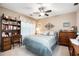 Comfortable bedroom with a ceiling fan, study desk, and ample closet space at 1625 Rushing River Way, Suwanee, GA 30024