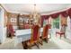 Elegant dining room with decorative wallpaper, chandelier, and large window at 1625 Rushing River Way, Suwanee, GA 30024