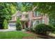Charming two-story home featuring a well-manicured lawn, a two-car garage, and a welcoming front porch at 1625 Rushing River Way, Suwanee, GA 30024