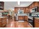 Well-equipped kitchen with stainless steel appliances, wooden cabinets, and convenient layout at 1625 Rushing River Way, Suwanee, GA 30024