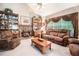 Cozy living room featuring a brick fireplace, plush seating, and ample natural light at 1625 Rushing River Way, Suwanee, GA 30024