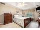 Comfortable bedroom features a ceiling fan, neutral walls, and plush carpeting at 1625 Rushing River Way, Suwanee, GA 30024