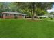 Manicured front lawn and mature trees surround a classic single-story brick residence at 2858 Valley Ridge Dr, Decatur, GA 30032