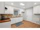 Kitchen featuring white cabinets, granite countertops, and tile backsplash and flooring at 2858 Valley Ridge Dr, Decatur, GA 30032