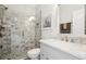 Updated bathroom with glass shower, gray tile and granite countertop at 333 Lauren Ln, Woodstock, GA 30188