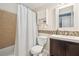 Bright bathroom with a shower-tub combo, updated vanity, mosaic tile accent, and convenient storage at 333 Lauren Ln, Woodstock, GA 30188