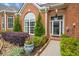 A home's front entrance surrounded by lush landscaping and a pathway to the front door at 333 Lauren Ln, Woodstock, GA 30188