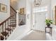 Bright foyer with staircase featuring hardwood stairs, and a striking light fixture at 333 Lauren Ln, Woodstock, GA 30188