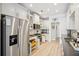 Modern kitchen featuring stainless steel appliances, white cabinets, and hardwood floors at 333 Lauren Ln, Woodstock, GA 30188