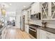 Modern kitchen featuring white cabinets, stainless steel appliances, and sleek countertops at 333 Lauren Ln, Woodstock, GA 30188