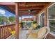 Charming covered patio featuring comfortable seating, a ceiling fan, and views of the surrounding neighborhood and pool at 333 Lauren Ln, Woodstock, GA 30188