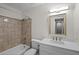 Bathroom featuring a tub/shower combo and tiled walls at 4960 Meadow Ln, Marietta, GA 30068