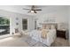 Light-filled bedroom with a ceiling fan, plush carpet, and a calming color palette at 4960 Meadow Ln, Marietta, GA 30068