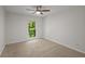 Simple bedroom with ceiling fan and a view to the outside at 4960 Meadow Ln, Marietta, GA 30068