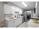Modern kitchen with stainless steel appliances, sleek white cabinetry, and granite countertops at 4960 Meadow Ln, Marietta, GA 30068