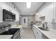 Bright kitchen features new white cabinetry, stainless steel appliances, and ample countertop space at 4960 Meadow Ln, Marietta, GA 30068
