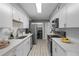 Galley-style kitchen features stainless appliances, ample counter space, and a modern, clean design at 4960 Meadow Ln, Marietta, GA 30068