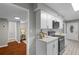 Charming kitchen with white cabinets, stainless steel appliances, and a view to the living room at 4960 Meadow Ln, Marietta, GA 30068