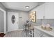 This modern kitchen nook boasts bright lighting and features a small table and chairs at 4960 Meadow Ln, Marietta, GA 30068