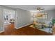 Inviting living room with hardwood floors, ceiling fan, neutral tones, and stylish accent furniture at 4960 Meadow Ln, Marietta, GA 30068