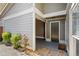 Covered side entrance featuring a secure door and convenient access to an open carport with stone pavers at 4960 Meadow Ln, Marietta, GA 30068