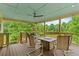 Relax on this back porch with a ceiling fan, fire pit and wooded acreage views at 638 Glen Valley Way, Dacula, GA 30019