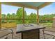 Beautiful enclosed back porch with a fire table to enjoy nature at 638 Glen Valley Way, Dacula, GA 30019