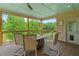 Enclosed back porch with a fire table and seating to enjoy the natural views at 638 Glen Valley Way, Dacula, GA 30019