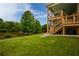 Well-manicured lawn leads to a two-story screened-in porch and staircase down to the green backyard and lake at 638 Glen Valley Way, Dacula, GA 30019