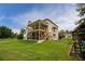 Large backyard featuring a spacious lawn, fenced perimeter, and a charming two-story screened-in porch at 638 Glen Valley Way, Dacula, GA 30019