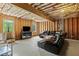 Partially finished basement with leather sofa and TV on entertainment center at 638 Glen Valley Way, Dacula, GA 30019