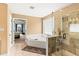 Large bathroom showcasing a shower, soaking tub, and neutral wall and floor tiles at 638 Glen Valley Way, Dacula, GA 30019