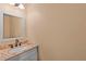 Powder room with granite countertops, blue vanity and decorative mirror at 638 Glen Valley Way, Dacula, GA 30019