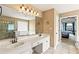 Bathroom featuring double sinks, tile floors, large mirrors, and a separate shower and tub at 638 Glen Valley Way, Dacula, GA 30019