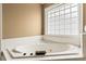Bright, spacious bathroom featuring a large bathtub under a window and tile surround at 638 Glen Valley Way, Dacula, GA 30019