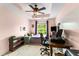 Bedroom featuring tray ceiling, ceiling fan, large window, desk, and good natural light at 638 Glen Valley Way, Dacula, GA 30019